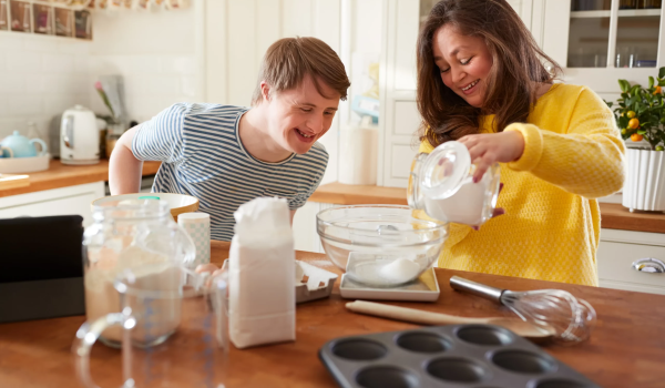 young-downs-syndrome-couple-baking-in-kitchen-at-h-2023-11-27-05-14-46-utc-scaled